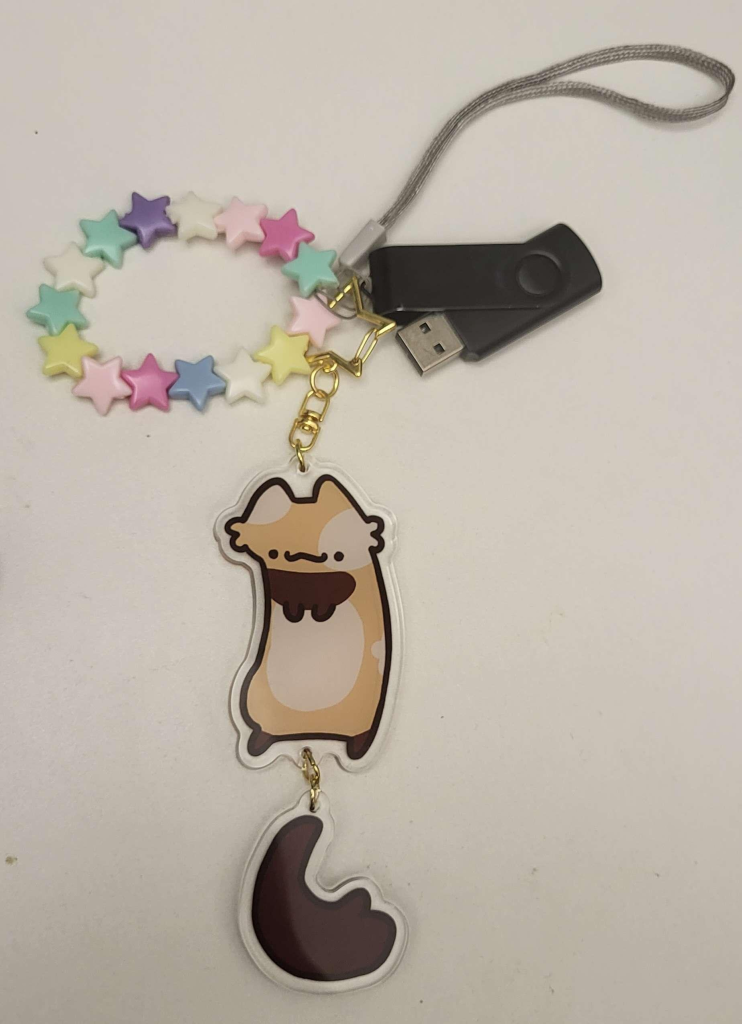 A flashdrive USB connected to a cute keychain.